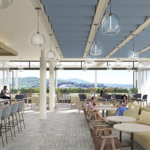 A bright, modern rooftop lounge with seating, a bar, and people chatting, overlooking a scenic outdoor view and blue skies.