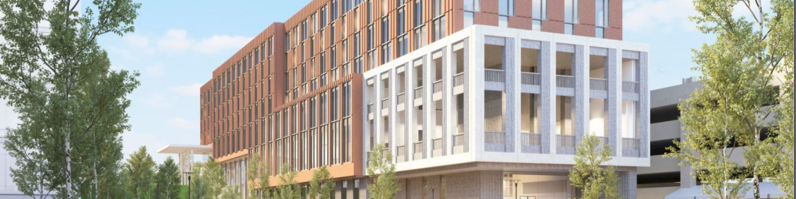 Modern multi-story building with brick and white framed facade, glass windows, surrounding greenery, and a water feature in the foreground.