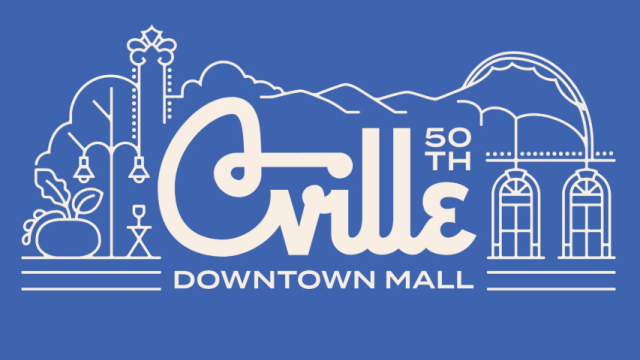A stylized white line drawing of a cityscape with the text &ldquo;Ville 50th Downtown Mall&rdquo; on a blue background, featuring arches, trees, and mountains.