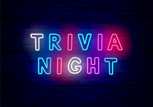 A neon sign reading &ldquo;TRIVIA&rdquo; and &ldquo;NIGHT&rdquo; glowing in bright blue, pink, and purple against a dark brick wall background.